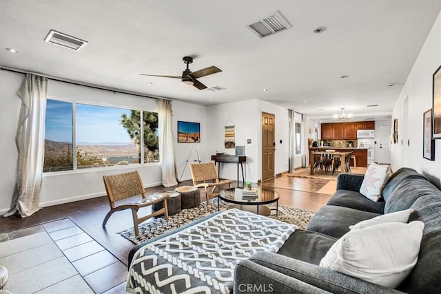 living room featuring ceiling fan and light hardwood / wood-style flooring