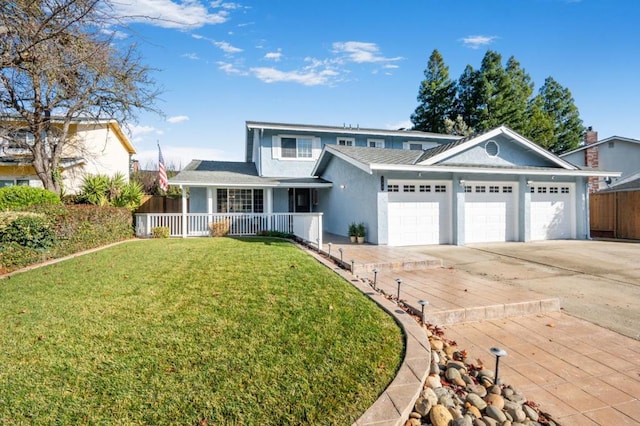 front of property with a garage, covered porch, and a front lawn