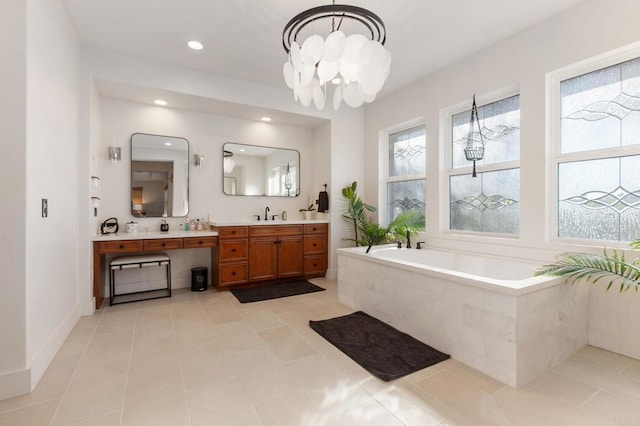 bathroom featuring vanity, tile patterned floors, a relaxing tiled tub, and a chandelier