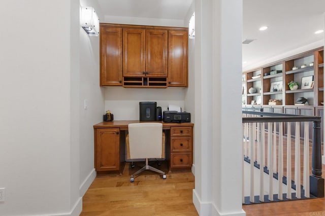 office with light hardwood / wood-style flooring