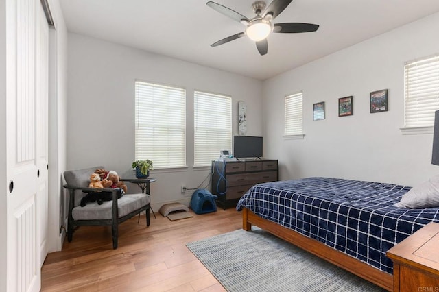 bedroom with ceiling fan, a closet, and hardwood / wood-style floors