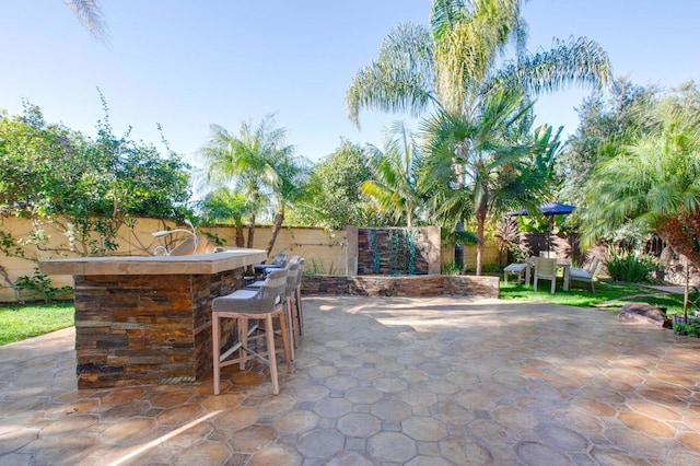 view of patio / terrace featuring an outdoor bar