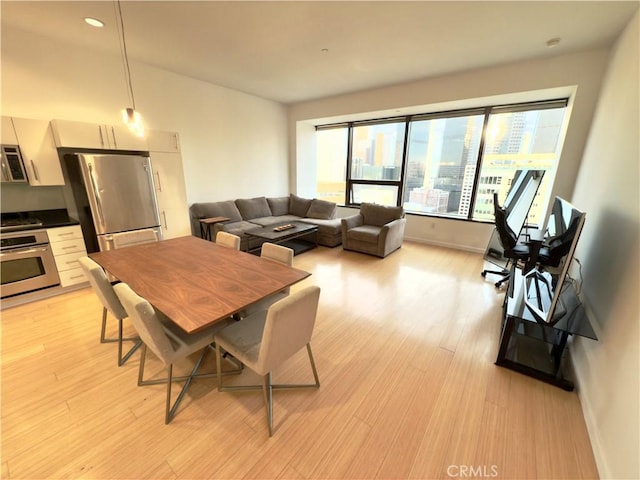 dining area featuring light wood-type flooring