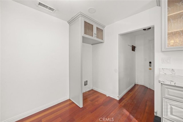 laundry room with dark hardwood / wood-style flooring