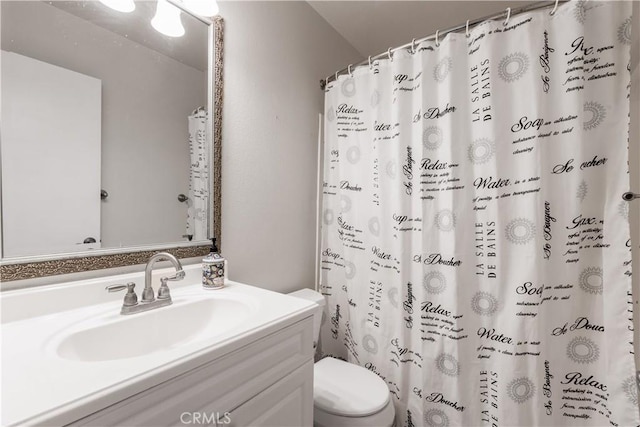 bathroom featuring vanity, toilet, and a shower with curtain