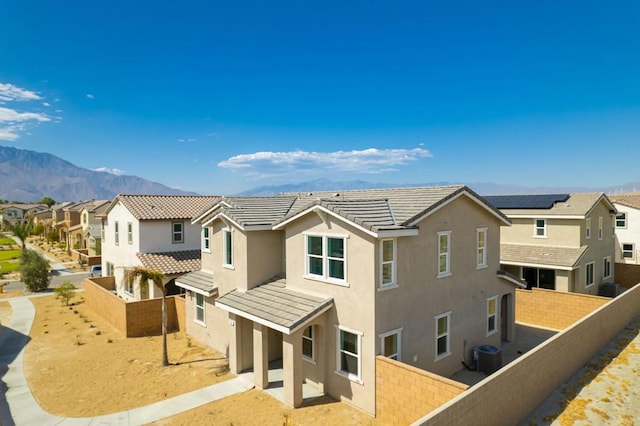 exterior space with central AC unit and a mountain view