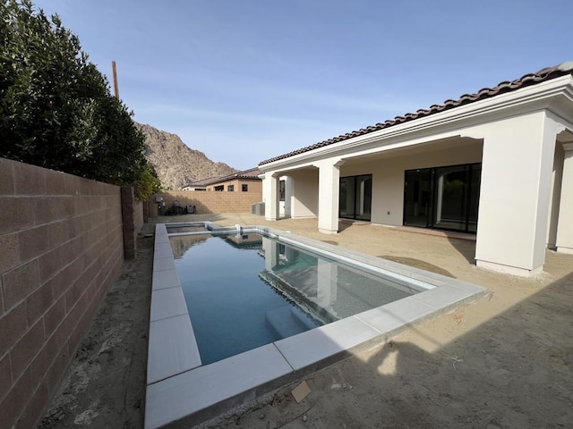 view of pool featuring a mountain view and a patio area