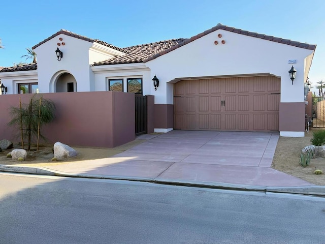 mediterranean / spanish home featuring a garage