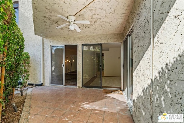 entrance to property featuring ceiling fan and a patio area