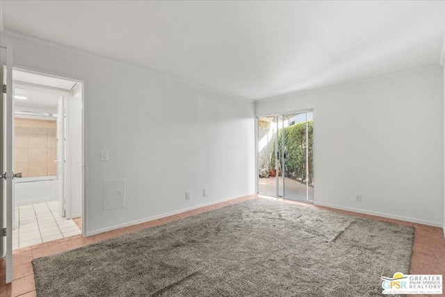 tiled empty room featuring crown molding