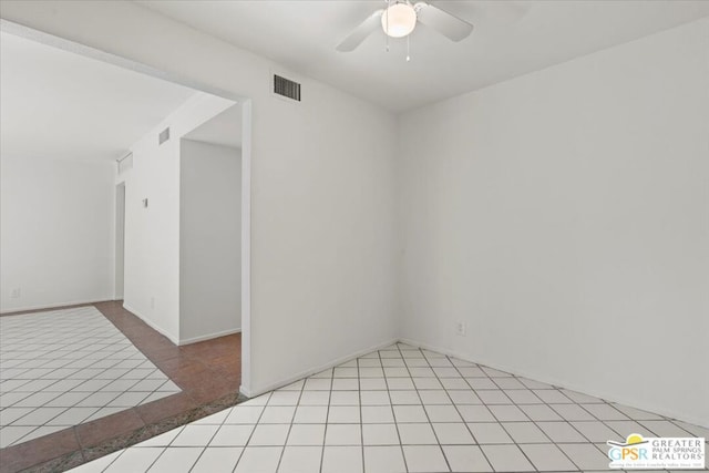 unfurnished room with ceiling fan and light tile patterned floors