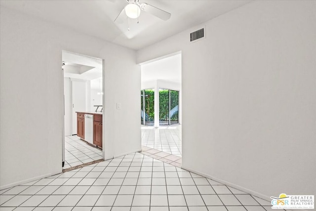 spare room featuring ceiling fan and light tile patterned floors