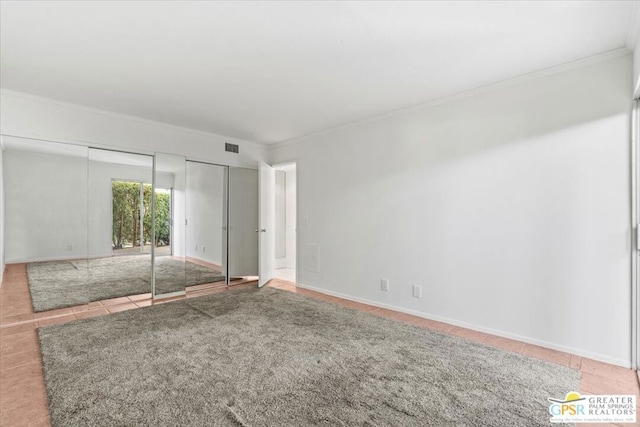 unfurnished bedroom featuring tile patterned floors and ornamental molding