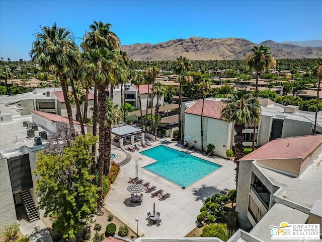 view of pool featuring a mountain view and a patio