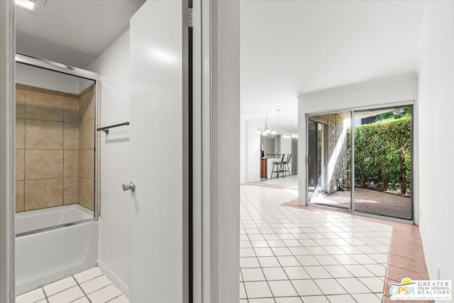 bathroom featuring a notable chandelier, tile patterned floors, shower / bath combination with glass door, and ornamental molding