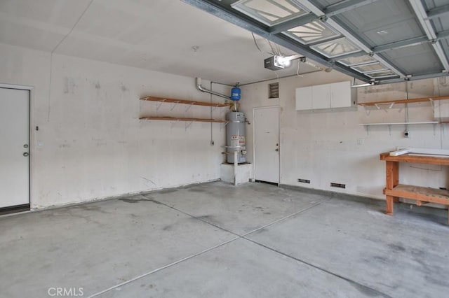 garage featuring secured water heater and a garage door opener