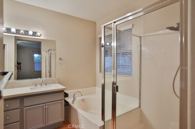 bathroom with separate shower and tub and vanity