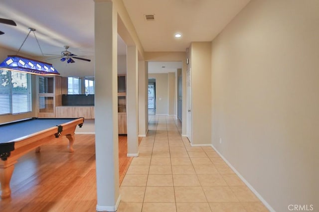 hall with light tile patterned floors