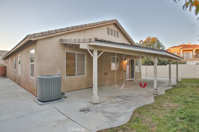 back of house with a patio and central AC