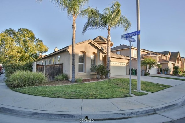 view of front facade featuring a garage and a front lawn