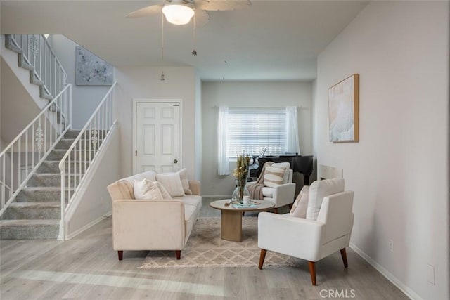 living area with ceiling fan and light hardwood / wood-style floors