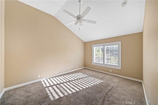 carpeted empty room with ceiling fan and lofted ceiling