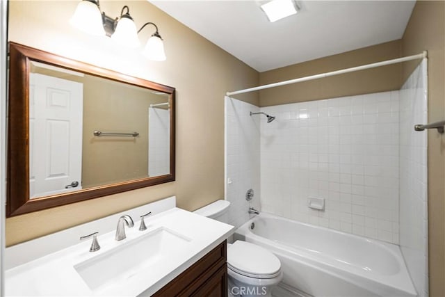 full bathroom with toilet, vanity, and tiled shower / bath