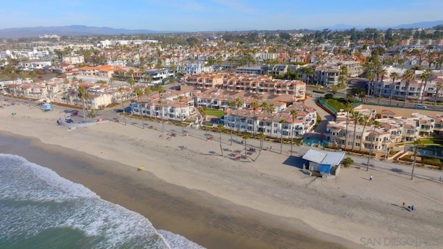 drone / aerial view with a beach view and a water view