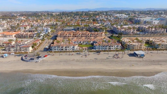 birds eye view of property with a beach view and a water view