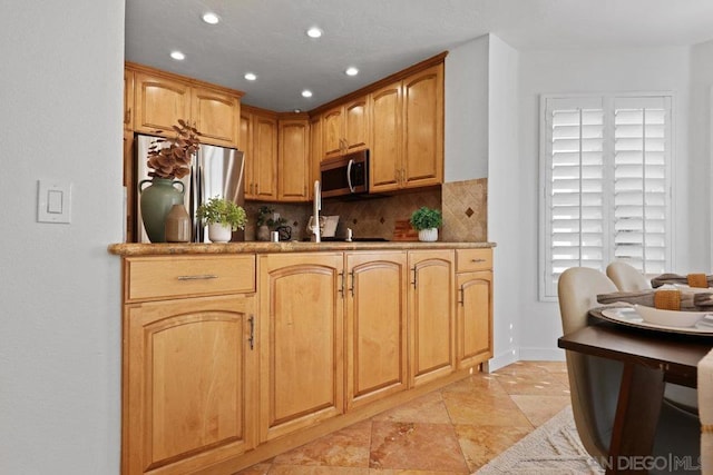 kitchen featuring tasteful backsplash, stainless steel appliances, and sink