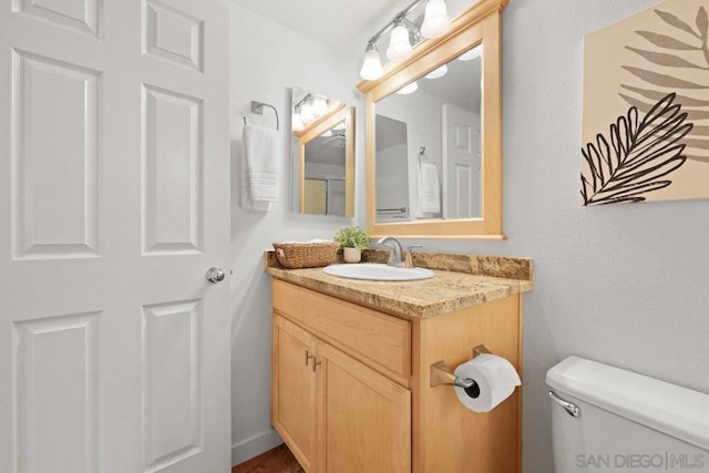 bathroom featuring vanity and toilet