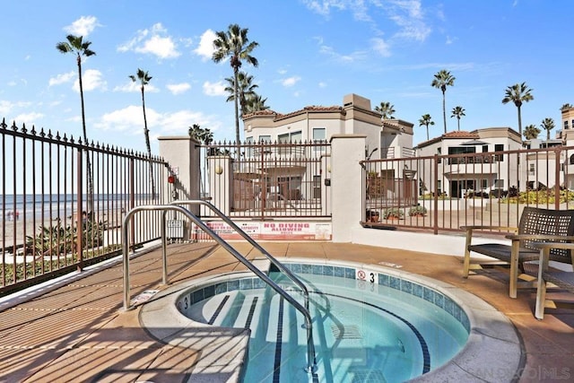 view of swimming pool featuring a hot tub