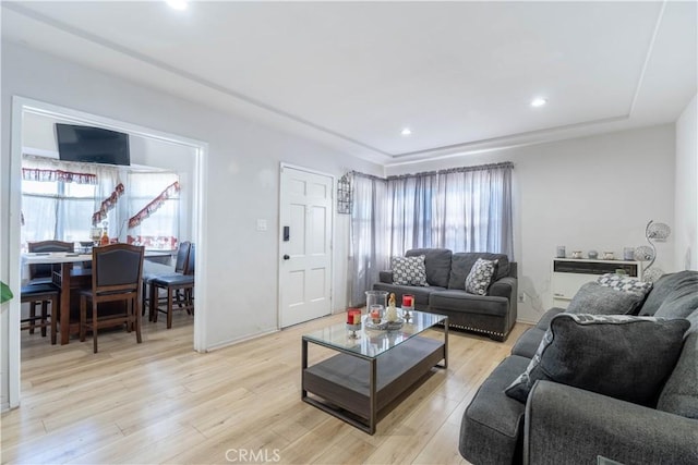 living room featuring plenty of natural light and light hardwood / wood-style floors