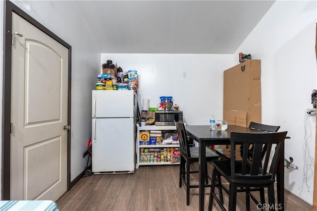 dining space with hardwood / wood-style floors