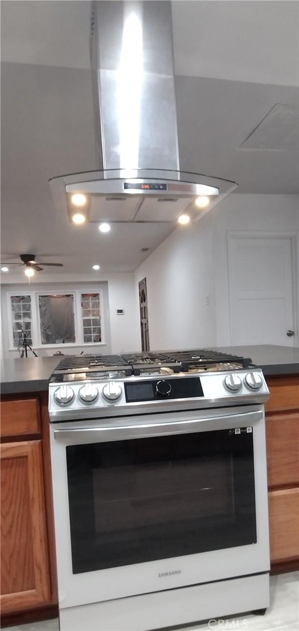 kitchen featuring island range hood and stainless steel gas range