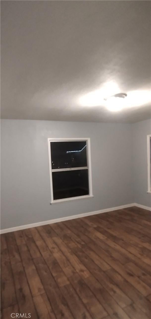 spare room with dark hardwood / wood-style flooring