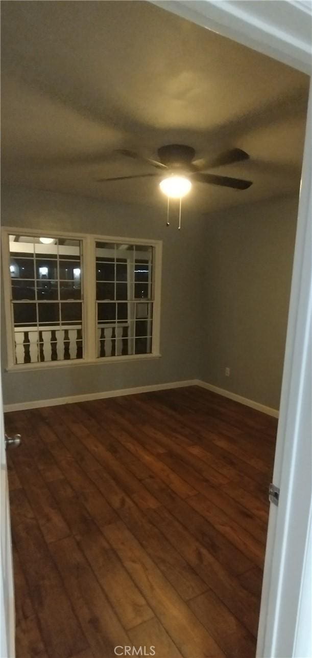 spare room featuring ceiling fan and dark hardwood / wood-style flooring