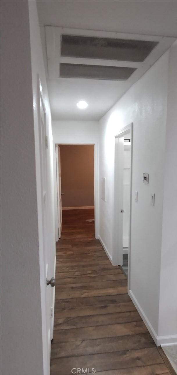 corridor with dark hardwood / wood-style floors