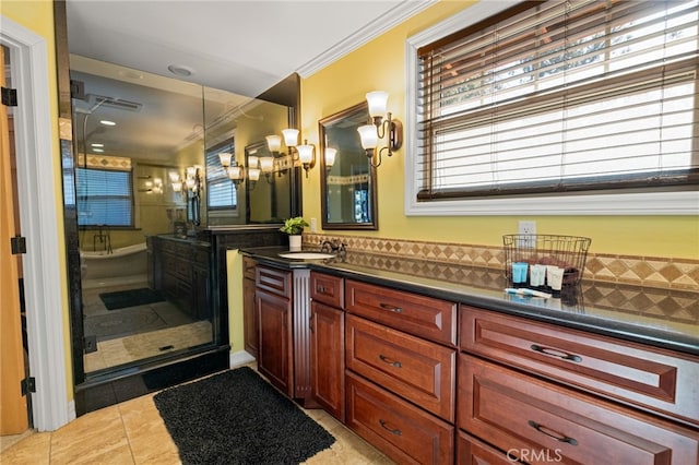 bathroom featuring walk in shower, vanity, tile patterned floors, and crown molding