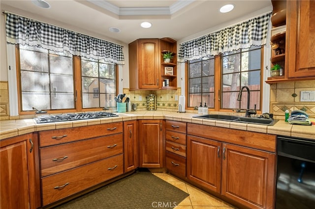 kitchen featuring stainless steel gas cooktop, decorative backsplash, sink, and tile countertops