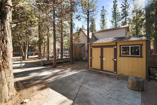 exterior space featuring a storage shed and a patio