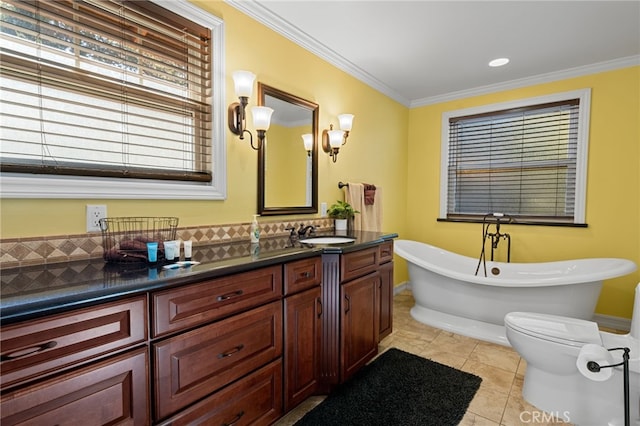 bathroom with a tub to relax in, vanity, tile patterned flooring, and ornamental molding