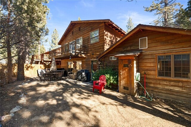 back of property with a balcony and a patio