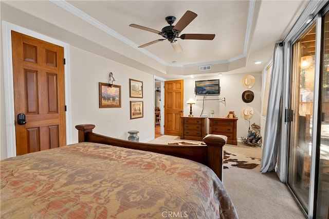 carpeted bedroom featuring ceiling fan, access to outside, a tray ceiling, and ornamental molding