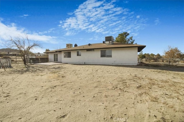 rear view of house featuring cooling unit and a patio