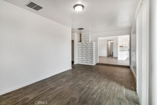 unfurnished living room with dark wood-type flooring