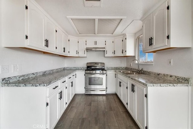 kitchen featuring light stone counters, sink, white cabinetry, and gas stove