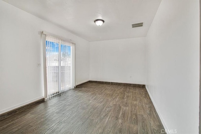 spare room with dark hardwood / wood-style floors