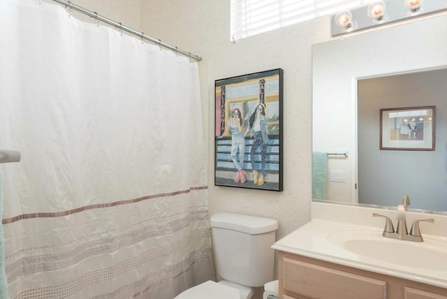 bathroom featuring toilet and vanity