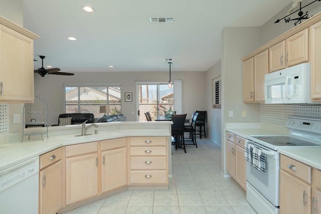 kitchen featuring ceiling fan, kitchen peninsula, sink, white appliances, and hanging light fixtures